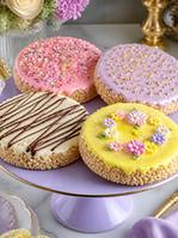 Giant round crispy rice treats, each iced and decorated a different way