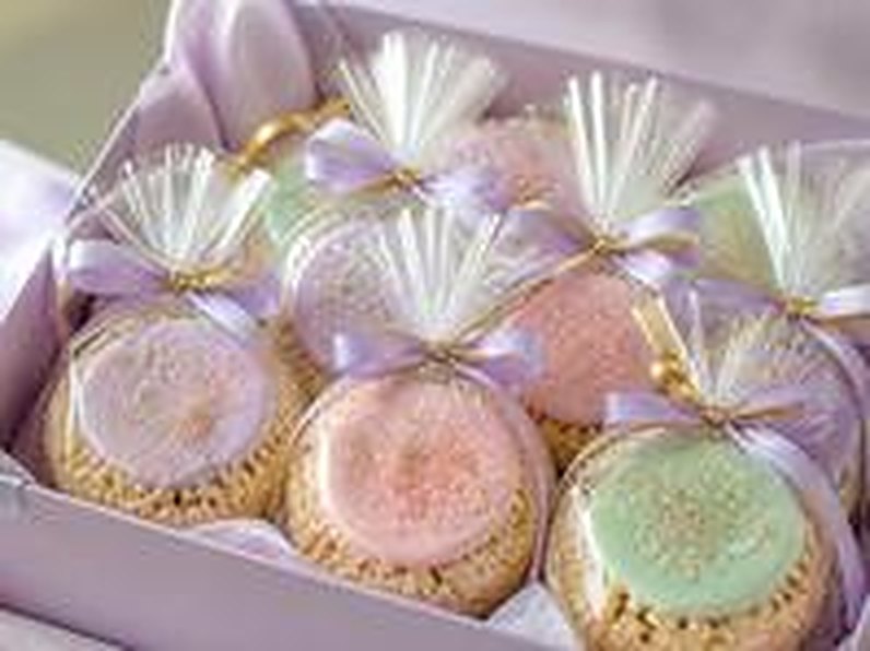 Round iced treats wrapped as party favors